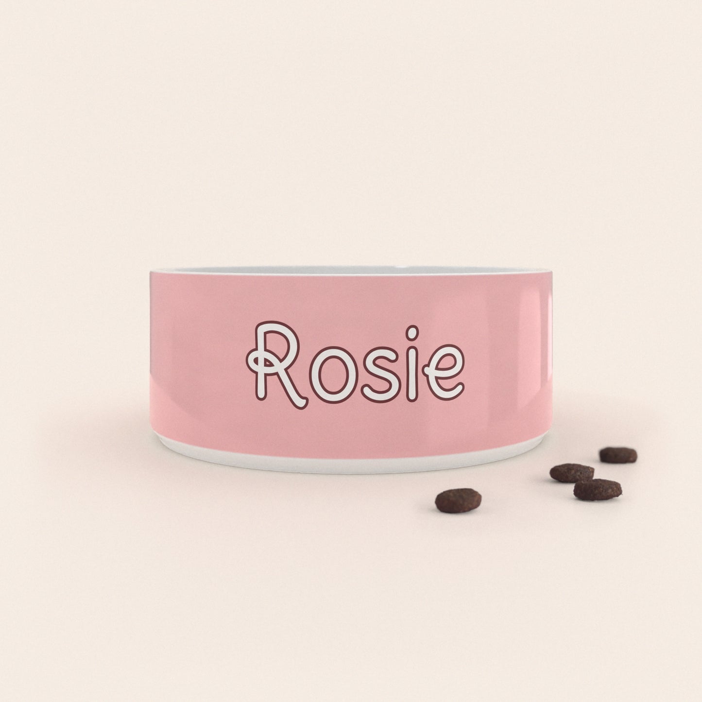 Gamelle pour chien au motif Rose Pastel personnalisés avec le nom Rosie, accompagné de croquettes sur fond neutre.